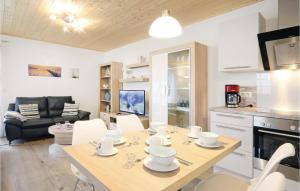 a kitchen and living room with a table and chairs at Ferienhaus 32 Altefhr in Altefähr