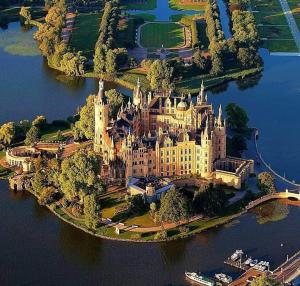 an island with a castle in the middle of the water at Ostorfer See in Schwerin