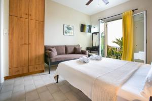 a bedroom with a large bed and a couch at Irena Studios & Apartments in Sarláta