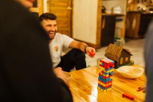 a man playing with a toy house on a table at Cabana La Cuib Sovata in Sovata