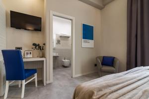 a bedroom with a bed and a desk and a television at Cinque Terre Gateway in La Spezia