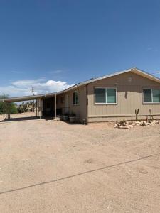 a house in a field with a dirt lot at Rare four Bedroom MeadviewVacation Home - Grand Canyon West-Skywalk in Meadview