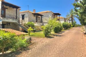 a brick road in front of a house at Ntinos House Elani Halkidiki in Siviri