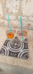 three glasses of drinks with straws on a table at Nona Ružica in Vis
