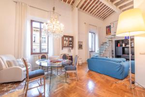 a living room with a blue couch and a table at Piombino Apartments - Casa Fucini in Piombino