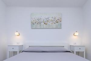 a bedroom with a bed and two night stands at Krcina Holiday Home in Cres