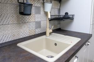 a white sink in a kitchen with at Krcina Holiday Home in Cres