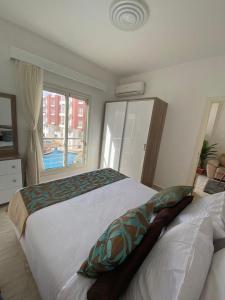 a bedroom with two beds and a window at Elegant and Welcoming one bedroom apartment in Hurghada