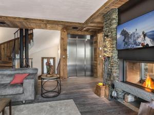 a living room with a fireplace and a tv at Chalet de Luxe 7 Ch, Piscine & Hammam, Animaux Admis - FR-1-566-5 in Les Allues +8 photos