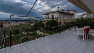 a balcony with a table and chairs and a building at Nikolas apartment II in Nafplio