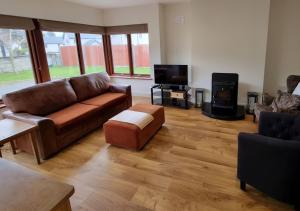 a living room with a couch and a fire place at 4 bedroom Holiday Home In Union Hall, West Cork in Union Hall