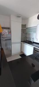 a kitchen with a stainless steel refrigerator and stove at Jose Luis Arenas del Mar Torre 1 in Punta del Este