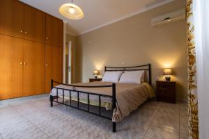 a bedroom with a large bed and a wooden cabinet at Nikolas apartment II in Nafplio