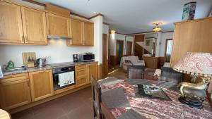 a kitchen with wooden cabinets and a table in a room at Villa Moderna in Jūrmala
