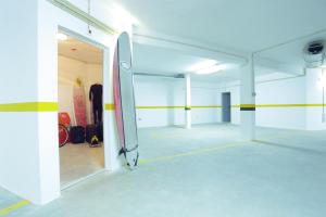 an empty parking lot with a door open to a room with skateboards at Sagres Time Apartamentos in Sagres