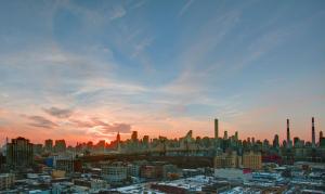 a view of a city skyline at sunset at Boro Hotel in Queens