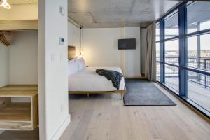 a bedroom with a bed and a large window at Boro Hotel in Queens