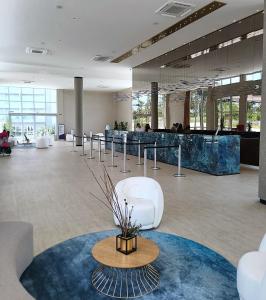 a large room with a lobby with a table and chairs at Aqualand Park & Resort Oficial in Salinópolis