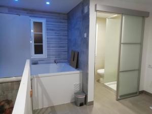 a bathroom with a large tub and a toilet at La Casita de Ubrique in Ubrique +84 photos