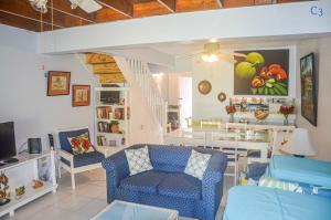 a living room with a couch and a table at Condo Rios Resort in Ocho Rios