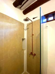 a shower with a glass door in a bathroom at Hotel Tierra Roja By MH in Barichara