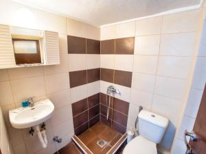a bathroom with a toilet and a sink at Prassas Sea View in Nea Potidaea +32 photos