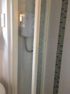 a shower in a bathroom with a glass door at Tamar Valley, Cornwall in Callington