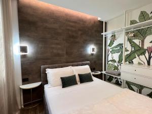 a bedroom with a white bed and a brown wall at DR54 Apartments in Rho