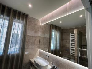 a bathroom with a sink and a mirror at DR54 Apartments in Rho