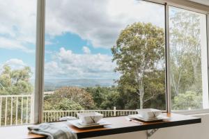 a large window with a view of the mountains at Tinarra Treetops in Maroochy River