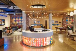a lobby with a ping pong table in the middle at Aloft by Marriott Louisville Downtown in Louisville