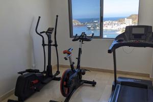 two exercise bikes in a room with a window at Luxuriöses Appartement mit Pool in Gaira
