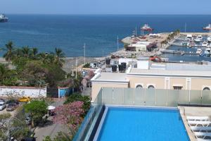 a resort with a pool and a view of the ocean at Luxuriöses Appartement mit Pool in Gaira