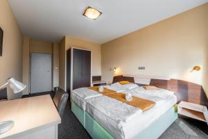 a bedroom with a large bed in a room at Penzion a Restaurant Barbora in Kutná Hora