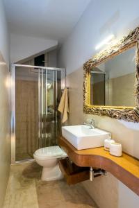 a bathroom with a sink and a toilet and a mirror at Coco Studio in Chania Town