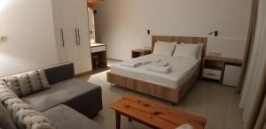 a hotel room with a bed and a couch at Lindos Pension in Dalyan