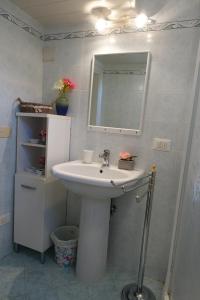 a bathroom with a white sink and a mirror at La casetta di campagna Alloggio nel Chianti in Pomino +30 photos