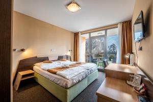 a hotel room with a bed and a window at Penzion a Restaurant Barbora in Kutná Hora