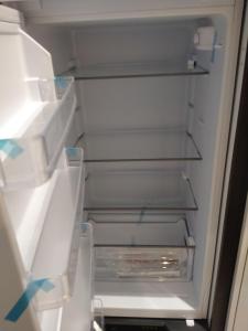 an empty refrigerator with its door open and its shelves at B&B Romeo in Bari