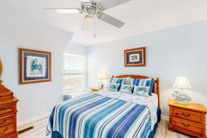 a bedroom with a bed and a ceiling fan at Tybee Stars in Tybee Island