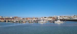 a group of boats are docked in a harbor at The Royal Oak Hotel in Ramsgate