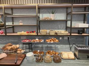 a shelf filled with different types of bread and pastries at Hotel Atlanta Knokke in Knokke-Heist