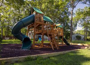 a playground with a slide in a park at Hamptons Vacation Inn in Hampton Bays