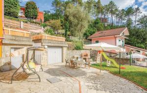 a backyard with a playground with a slide and an umbrella at La Quiete in Casarza Ligure