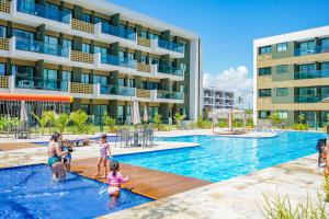 a family playing in the pool at a resort at Mana Beach Experience By Mai in Porto De Galinhas +30 photos
