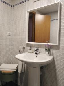 a bathroom with a white sink and a mirror at Sevilla Aljarafe Room in Bormujos