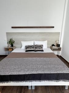a bedroom with a large white bed with two pillows at Fatolitis Studios in Masouri