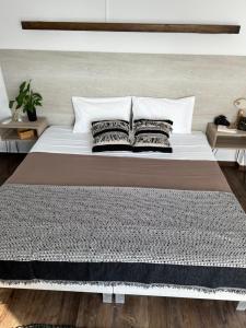 a bed with two pillows on it in a bedroom at Fatolitis Studios in Masouri