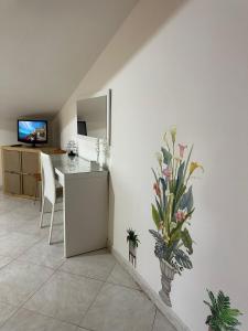 a kitchen with a table and a vase of flowers at Tramonto sul Mare in Agropoli
