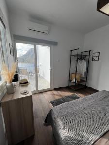 a bedroom with a bed and a view of the ocean at Fatolitis Studios in Masouri